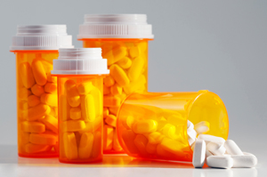 Prescription Medication Spilling From an Open Medicine Bottle