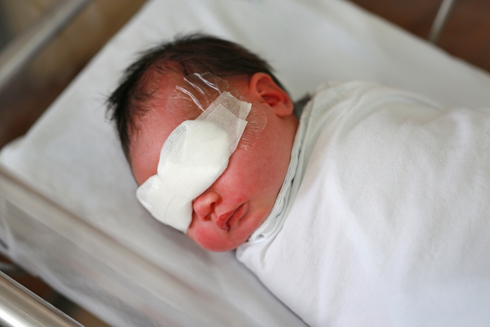 infant baby with blindfolded on the eyes