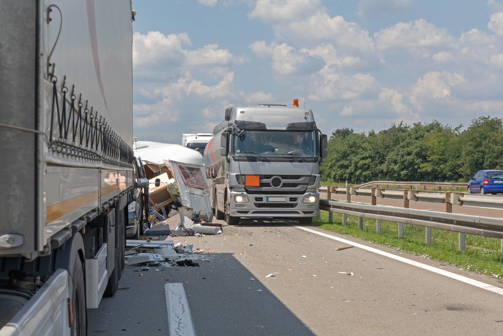 semi trucks and camper trailer traffic accident at highway
