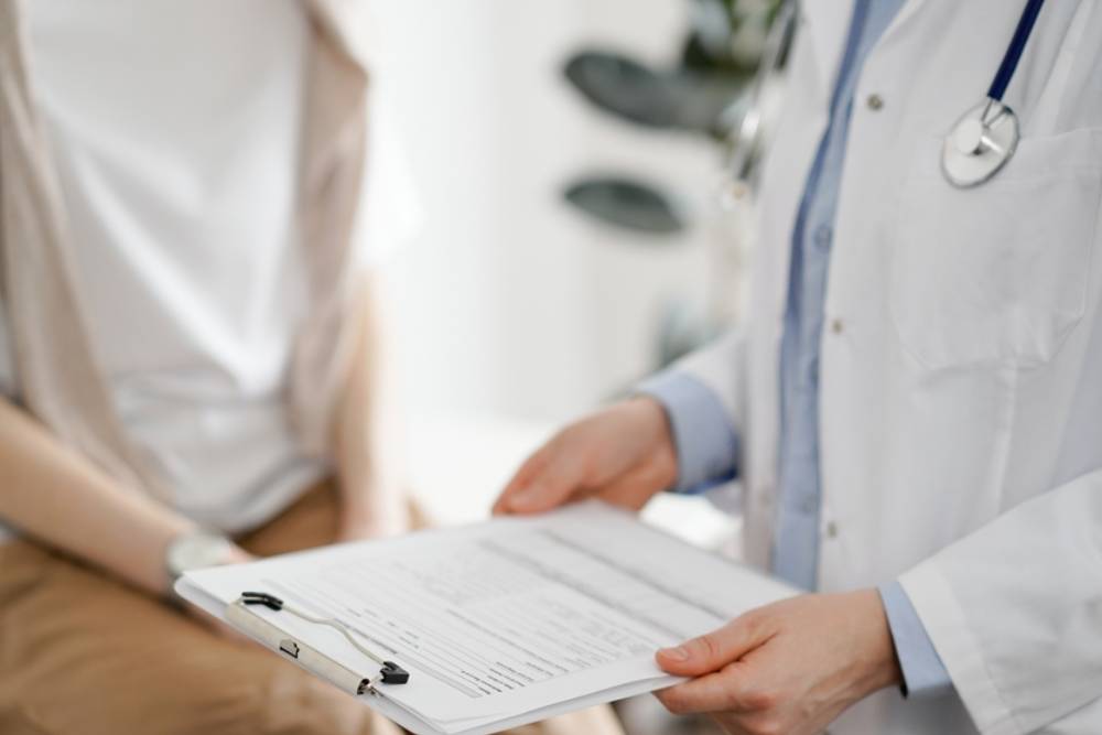 Doctor and patient discussing perfect health exam results