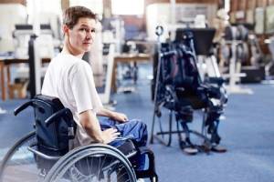 Man in wheelchair waiting for physical therapy