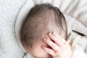 Baby scratches his head and blood oozes from the wound