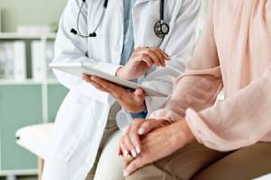 Clinic, tablet and hands of doctor with patient for consulting, medical service and help in hospital